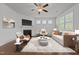Cozy living room with fireplace, ceiling fan, and an abundance of natural light at 1047 Aberlour Ln, Burlington, NC 27215