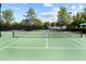 Well-maintained tennis court with a net and lush green surroundings, perfect for recreational play at 1047 Aberlour Ln, Burlington, NC 27215