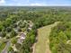 Aerial view of a residential community bordered by trees and a well-maintained golf course at 107 Weslyn Trace Dr, Durham, NC 27703