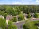 Aerial view of a neighborhood with tree-lined streets, manicured lawns, and brick homes at 107 Weslyn Trace Dr, Durham, NC 27703