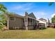 Home exterior with a screened porch, deck, and landscaped yard at 107 Weslyn Trace Dr, Durham, NC 27703