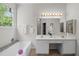 Bright bathroom with double sink vanity, soaking tub, and picture window at 107 Weslyn Trace Dr, Durham, NC 27703