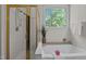 Soaking tub in bathroom with separate shower stall, window and tile flooring at 107 Weslyn Trace Dr, Durham, NC 27703
