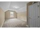 Neutral bedroom with beige walls, dormer ceiling, carpet, and window at 107 Weslyn Trace Dr, Durham, NC 27703