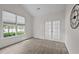 Well-lit bedroom featuring a cathedral ceiling, French doors, and large windows at 107 Weslyn Trace Dr, Durham, NC 27703
