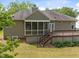 Home exterior with a screened porch, deck, and landscaped yard at 107 Weslyn Trace Dr, Durham, NC 27703