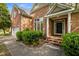 Welcoming front entrance with brick steps, lush landscaping, and a black front door at 107 Weslyn Trace Dr, Durham, NC 27703