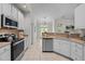 Well lit kitchen with neutral colors, stainless steel appliances and tile flooring at 107 Weslyn Trace Dr, Durham, NC 27703