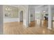 Spacious living room featuring hardwood floors, columns, and French doors leading to the patio at 107 Weslyn Trace Dr, Durham, NC 27703