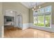 Bright living room with hardwood floors, large window, and elegant chandelier at 107 Weslyn Trace Dr, Durham, NC 27703