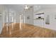 Open-concept living space with hardwood floors, columns, and view to the kitchen at 107 Weslyn Trace Dr, Durham, NC 27703