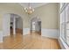 Open-concept living room features hardwood floors, wainscoting, and abundant natural light at 107 Weslyn Trace Dr, Durham, NC 27703
