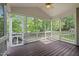 Relaxing screened porch with wooden floor and ceiling fan at 107 Weslyn Trace Dr, Durham, NC 27703