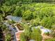 Aerial view of community amenities including tennis and pickleball courts, playground, surrounded by lush greenery at 107 Whitby Ct, Cary, NC 27511