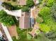 Bird's-eye view displays home with lush landscaping, garden plots, and outdoor entertaining areas at 107 Whitby Ct, Cary, NC 27511