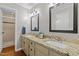 Bathroom with granite countertops, double sinks, and tiled shower at 107 Whitby Ct, Cary, NC 27511