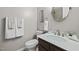 Stylish powder room with white countertops, wood vanity, and decorative towels, offering a refreshing space at 107 Whitby Ct, Cary, NC 27511
