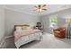 Bedroom with desk, comfy chair, and large window offering lots of natural light at 107 Whitby Ct, Cary, NC 27511