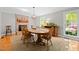 Elegant dining room with a brick fireplace, hardwood floors, and ample natural light at 107 Whitby Ct, Cary, NC 27511