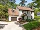 Charming two-story home with a well-manicured lawn, attached garage, and welcoming front entrance at 107 Whitby Ct, Cary, NC 27511