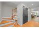 Inviting foyer featuring hardwood floors, staircase, and access to living areas at 107 Whitby Ct, Cary, NC 27511