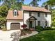 Charming two-story home with a landscaped front yard, attached garage and cozy covered entryway at 107 Whitby Ct, Cary, NC 27511
