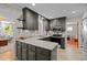 Gray kitchen featuring granite countertops, gray cabinets, stainless steel appliances, and tile flooring at 107 Whitby Ct, Cary, NC 27511