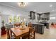 Modern kitchen open to the living room with granite countertops and stainless steel appliances at 107 Whitby Ct, Cary, NC 27511
