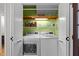 Convenient laundry room with modern washer and dryer, shelves for storage, offering practical functionality at 107 Whitby Ct, Cary, NC 27511