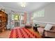 Cozy living room featuring french doors to porch, two sitting chairs, wood flooring, and area rug at 107 Whitby Ct, Cary, NC 27511