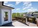 Back deck with wooden railings overlooking backyard and surrounding neighborhood, with access door to home at 108 Sunburst Dr, Durham, NC 27705