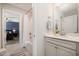 Bright, neutral bathroom with modern vanity, quartz countertop, and combination tub and shower with neutral tile at 108 Sunburst Dr, Durham, NC 27705