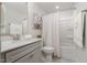 Bathroom featuring modern fixtures, neutral tiling, and clean design at 108 Sunburst Dr, Durham, NC 27705