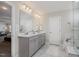 Bright bathroom with a double sink vanity, a large mirror, neutral walls, and tile flooring at 108 Sunburst Dr, Durham, NC 27705