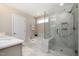 Modern bathroom featuring a glass shower, soaker tub, white tiling and neutral walls at 108 Sunburst Dr, Durham, NC 27705