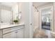 Bright, neutral bathroom with modern vanity, quartz countertop, and combination tub and shower with neutral tile at 108 Sunburst Dr, Durham, NC 27705