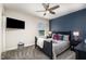 Charming bedroom with modern ceiling fan, blue accent wall, and comfortable bed with playful superhero theme at 108 Sunburst Dr, Durham, NC 27705