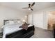 Bright bedroom featuring neutral walls, carpeting, and a ceiling fan, with lots of closet space at 108 Sunburst Dr, Durham, NC 27705