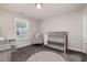 Cozy Bedroom features a wooden crib, comfy rocking chair, and soft round rug for a peaceful and inviting space at 108 Sunburst Dr, Durham, NC 27705