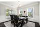 Bright dining area featuring a wood table, seating for six, and large windows at 108 Sunburst Dr, Durham, NC 27705