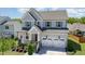 Beautiful two-story home featuring a two car garage and a charming covered front porch at 108 Sunburst Dr, Durham, NC 27705