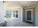 Covered front porch with a gray front door, a window, and a welcome mat at 108 Sunburst Dr, Durham, NC 27705