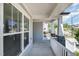 Covered front porch with stone pillars and white railings, with a view of the neighborhood at 108 Sunburst Dr, Durham, NC 27705