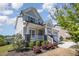 Landscaped front yard with a charming covered porch and stone accents on the home's facade at 108 Sunburst Dr, Durham, NC 27705