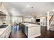 Open-concept kitchen with granite countertops, island, and stainless steel appliances at 108 Sunburst Dr, Durham, NC 27705