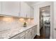 Bright kitchen featuring granite counters, white cabinets, and modern backsplash at 108 Sunburst Dr, Durham, NC 27705