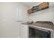 Functional laundry room features modern washer and dryer, organized shelving, and practical storage solutions at 108 Sunburst Dr, Durham, NC 27705