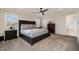 Bedroom featuring a dark wood bedframe, neutral carpeting, recessed lighting, and views from the two windows at 108 Sunburst Dr, Durham, NC 27705