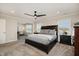 Spacious main bedroom with a ceiling fan and neutral carpet with lots of natural light from the two large windows at 108 Sunburst Dr, Durham, NC 27705