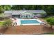 Aerial view showcases a home with a screened porch, large pool, patio, and beautifully landscaped backyard, perfect for outdoor living at 11 Pine Forest Dr, Siler City, NC 27344
